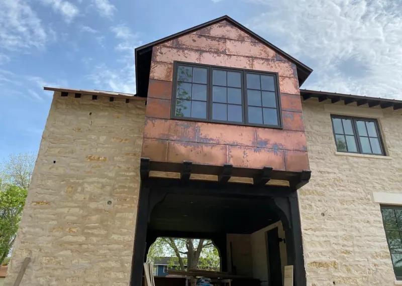 Copper metal panel facade on a stone building for Skylight Installation in Homer Glen